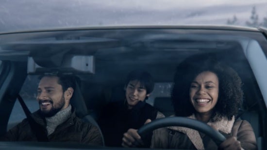 Three passengers riding in a vehicle and smiling | Reiselman Nissan in Kansas City MO