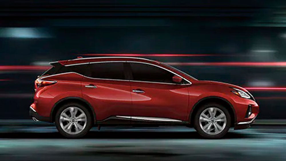 2023 Nissan Murano shown in profile driving down a street at night illustrating performance. | Reiselman Nissan in Kansas City MO